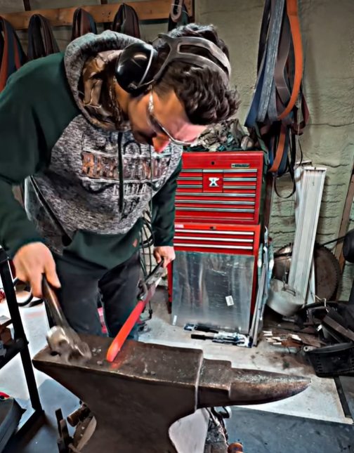 Kody Horsfield forging a blade